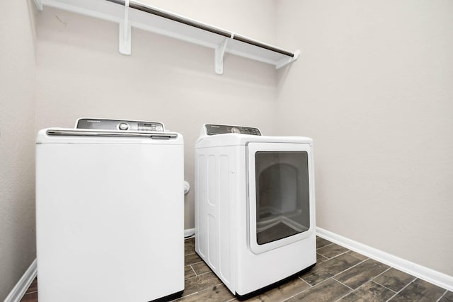 laundry room featuring washing machine and dryer and dark wood-type flooring