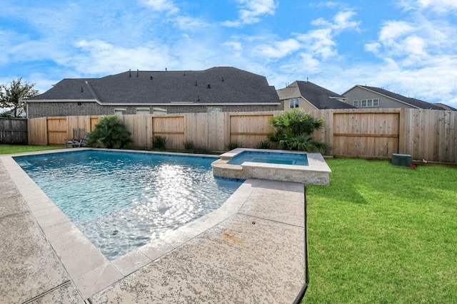 view of swimming pool featuring a lawn and an in ground hot tub