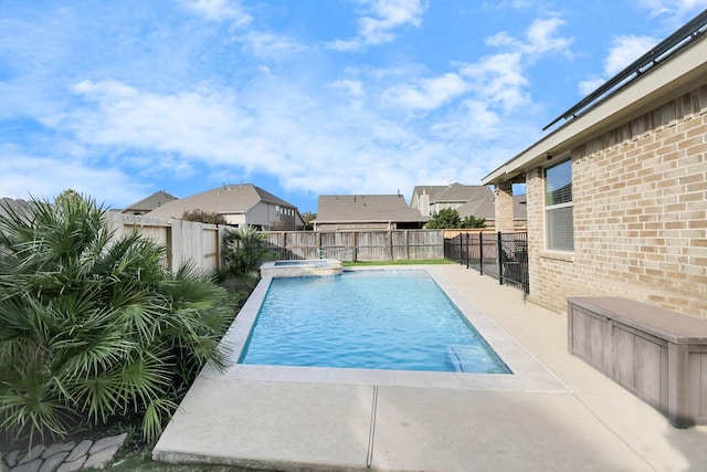 view of pool with an in ground hot tub