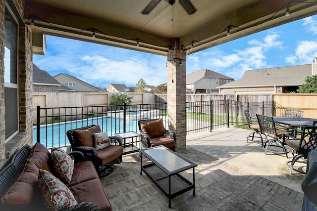 view of patio with a fenced in pool, an outdoor living space, and ceiling fan