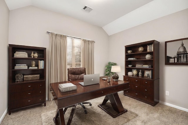 carpeted office space featuring vaulted ceiling