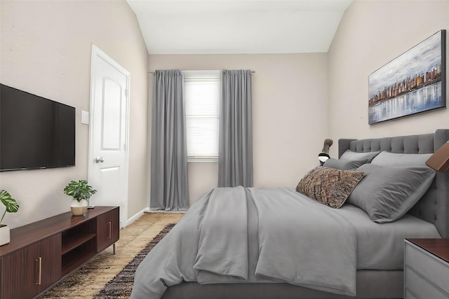 carpeted bedroom featuring lofted ceiling