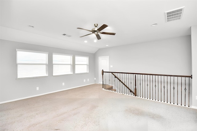 carpeted empty room featuring ceiling fan and vaulted ceiling