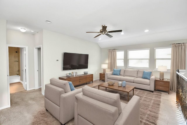 carpeted living room featuring ceiling fan and vaulted ceiling