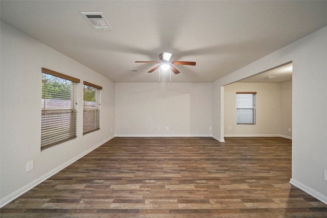 unfurnished room with ceiling fan and dark hardwood / wood-style flooring