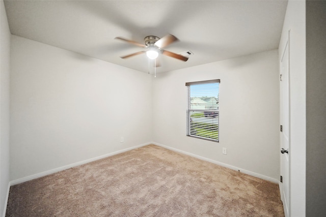 spare room featuring light carpet and ceiling fan