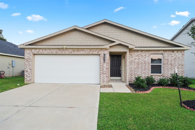 view of front of home with a garage and a front lawn