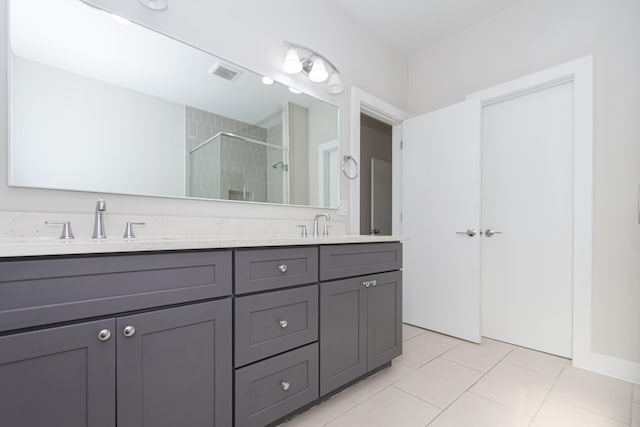 bathroom featuring vanity, tile patterned flooring, and an enclosed shower