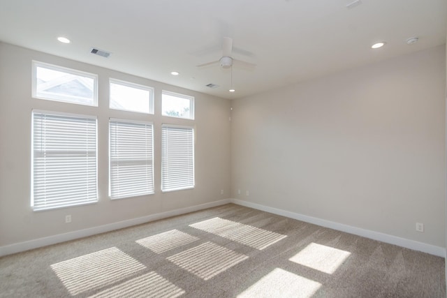 spare room with light carpet and ceiling fan