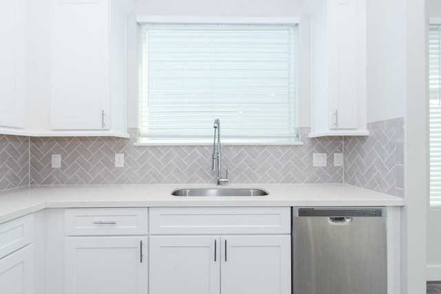 kitchen featuring sink, stainless steel dishwasher, and white cabinets