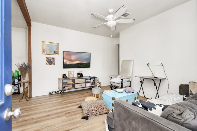 living room with hardwood / wood-style flooring and ceiling fan