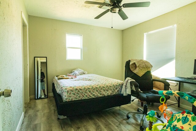 bedroom with ceiling fan and hardwood / wood-style floors