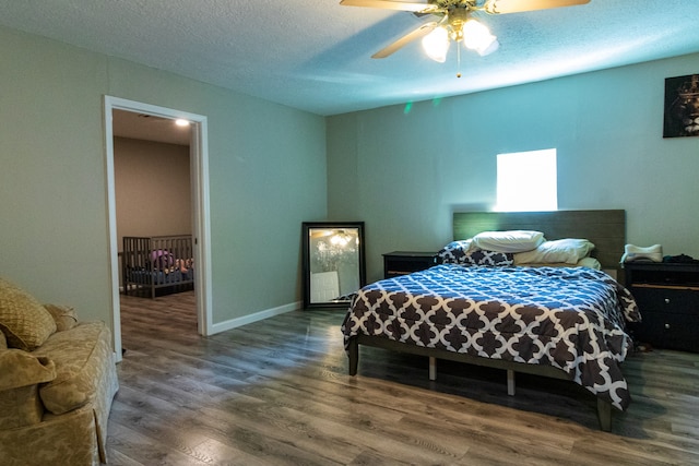 bedroom with hardwood / wood-style floors, a textured ceiling, and ceiling fan