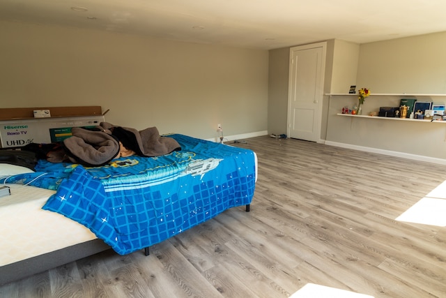 bedroom with hardwood / wood-style flooring