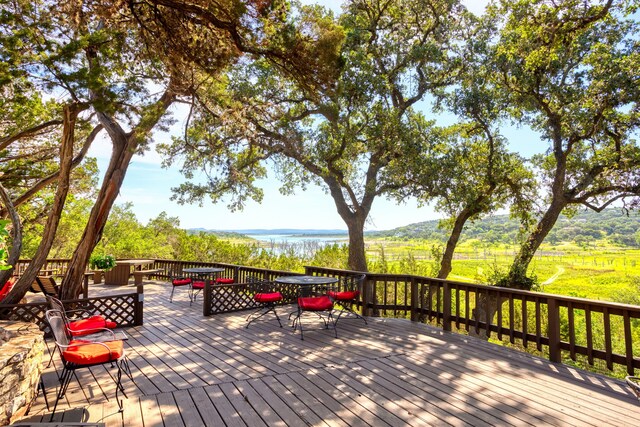 wooden terrace featuring a water view