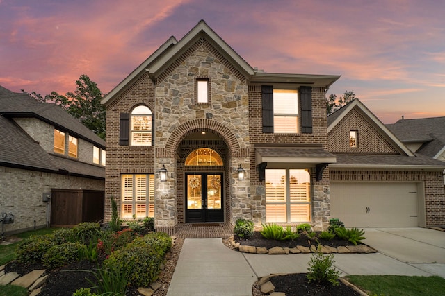 view of front of property with french doors and a garage