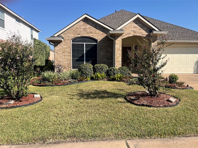 view of front of house featuring a garage and a front lawn