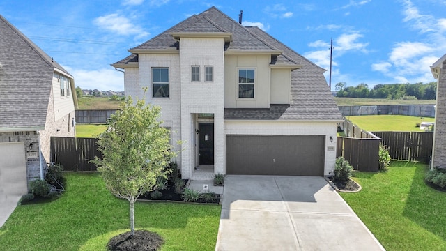 view of front of house featuring a front yard and a garage