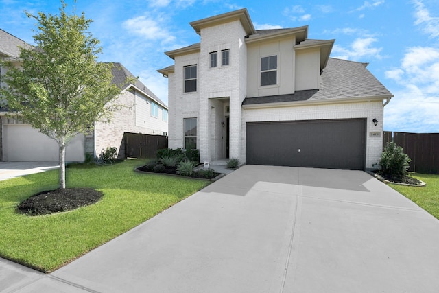 view of front of house with a front lawn and a garage