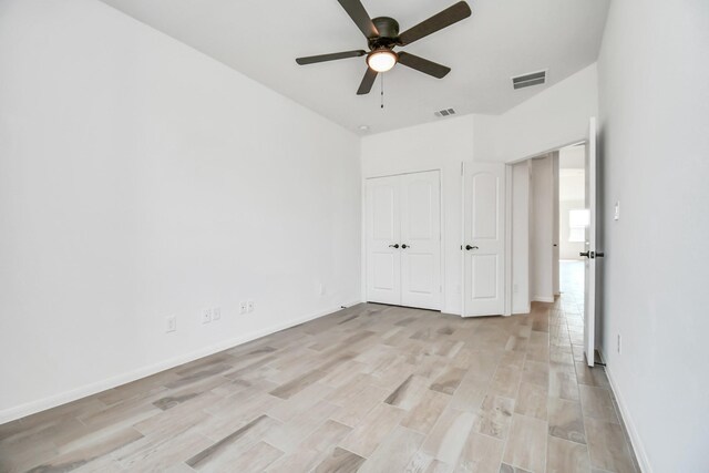 unfurnished bedroom featuring light hardwood / wood-style flooring, a closet, and ceiling fan