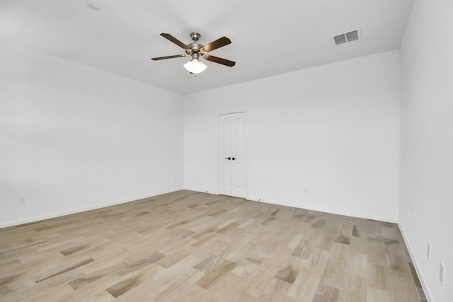 spare room featuring light hardwood / wood-style floors and ceiling fan