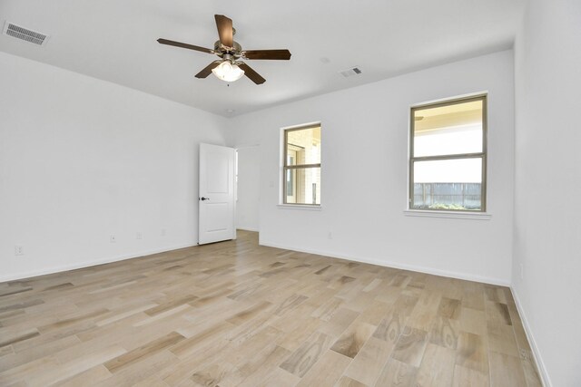 empty room with light wood-type flooring and ceiling fan