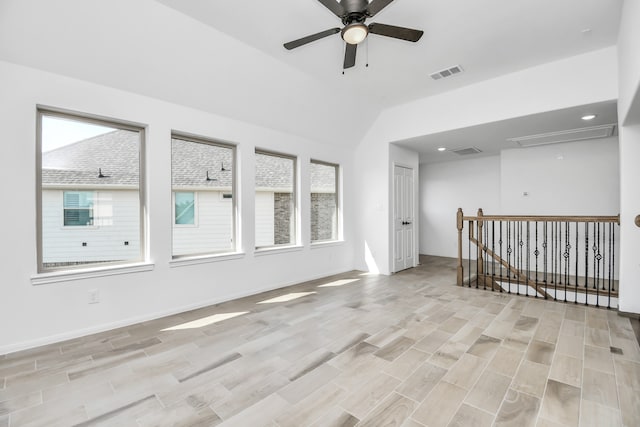 empty room featuring light hardwood / wood-style flooring, lofted ceiling, and ceiling fan