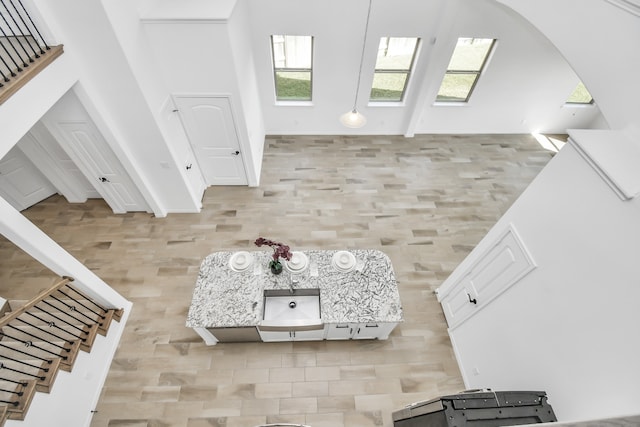 unfurnished living room featuring a towering ceiling