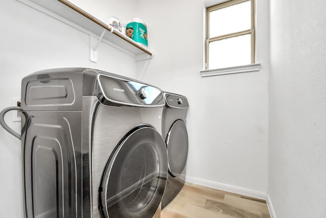 laundry room featuring light hardwood / wood-style flooring and independent washer and dryer