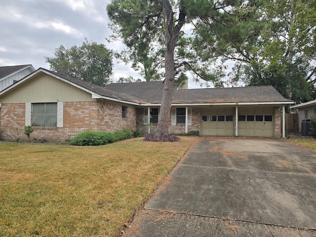 ranch-style house with a front lawn, central AC unit, and a garage