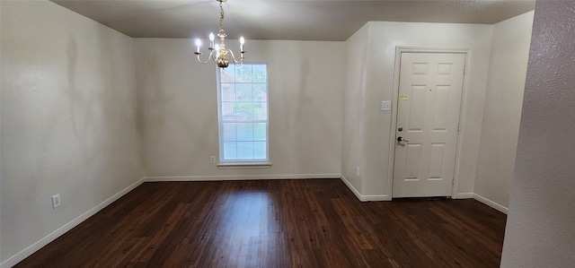 interior space with a notable chandelier and dark hardwood / wood-style flooring