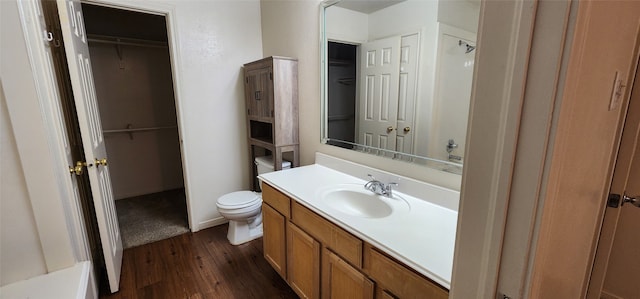 bathroom featuring vanity, toilet, and hardwood / wood-style floors