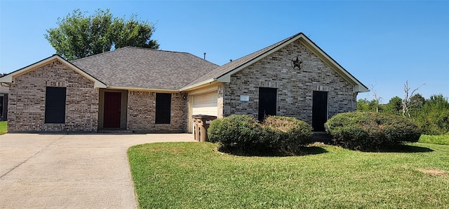 view of front of house featuring a front yard and a garage