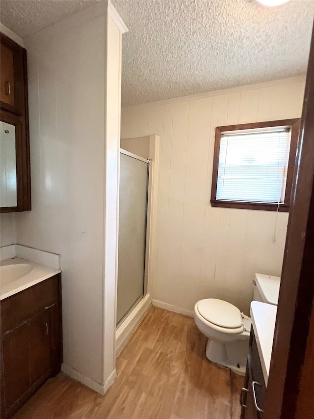 bathroom with vanity, an enclosed shower, and hardwood / wood-style floors