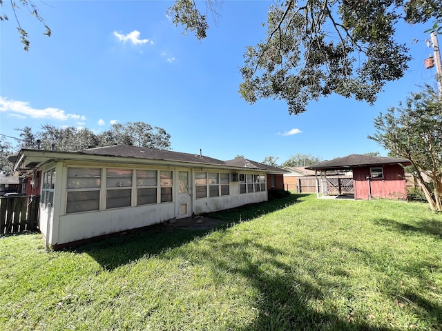 rear view of house featuring a lawn