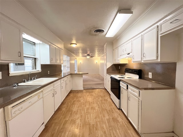 kitchen with white appliances, sink, kitchen peninsula, white cabinetry, and light hardwood / wood-style floors