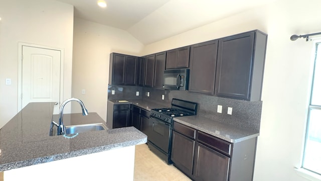 kitchen featuring black appliances, sink, backsplash, and vaulted ceiling