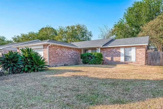 single story home featuring a garage and a front lawn