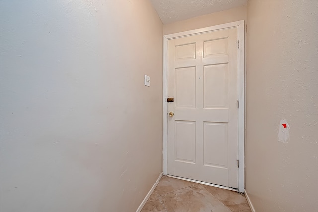 doorway with light tile patterned flooring