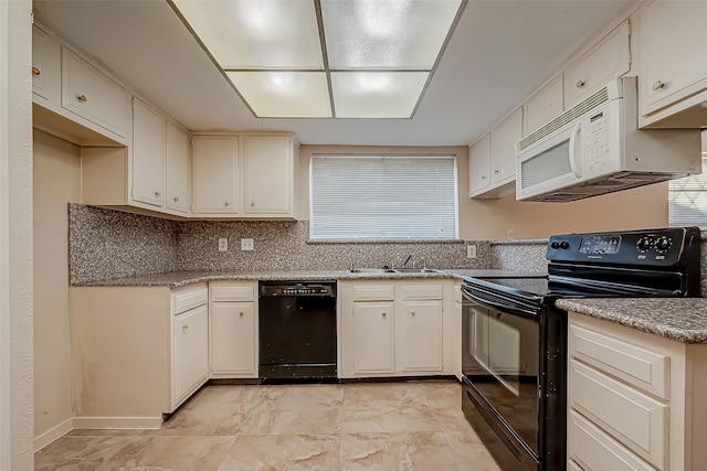 kitchen with black appliances, backsplash, white cabinetry, and sink