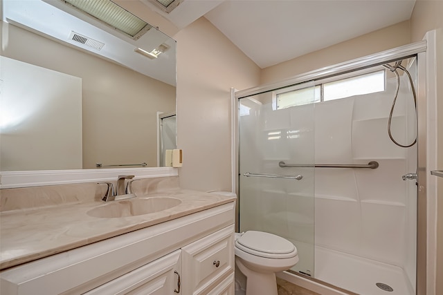 bathroom with vanity, toilet, a shower with door, and lofted ceiling