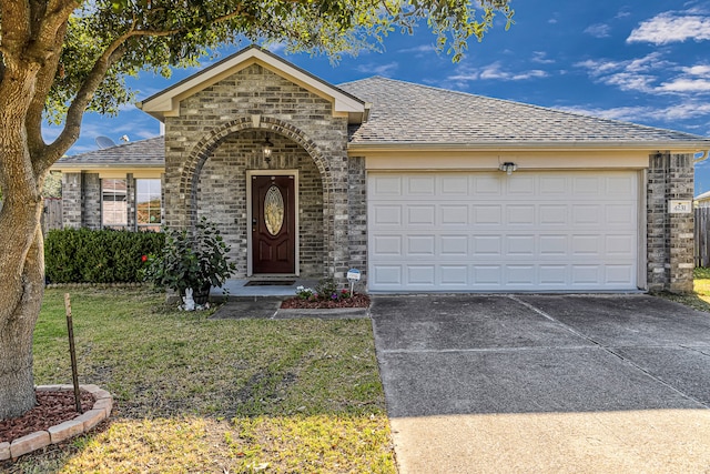 ranch-style home featuring a garage and a front lawn