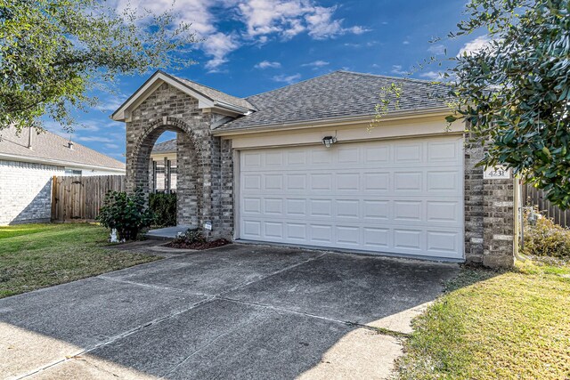 ranch-style house with a front yard and a garage