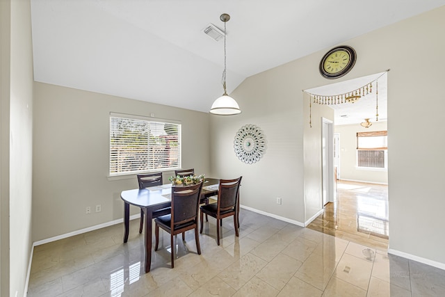 dining space with lofted ceiling