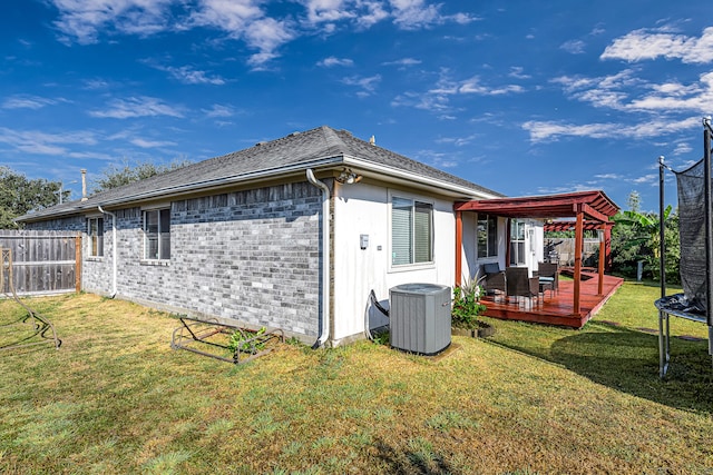 view of side of property featuring a pergola, a wooden deck, a lawn, and central air condition unit