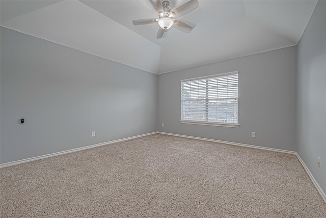 empty room featuring carpet floors, vaulted ceiling, and ceiling fan