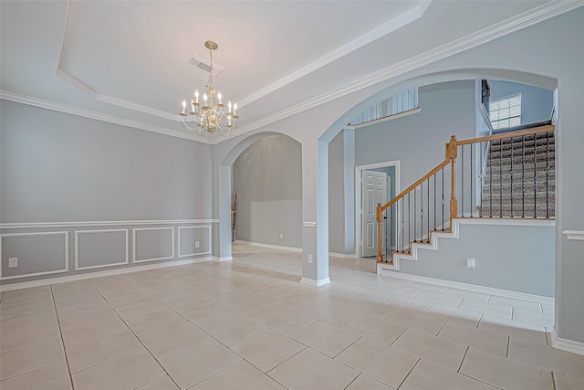 unfurnished room featuring a notable chandelier, light tile patterned floors, ornamental molding, and a tray ceiling