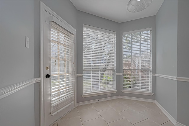 doorway to outside featuring light tile patterned flooring