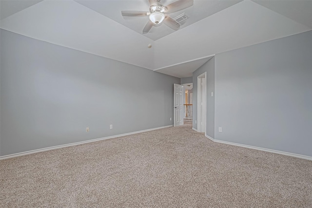 empty room featuring ceiling fan and carpet