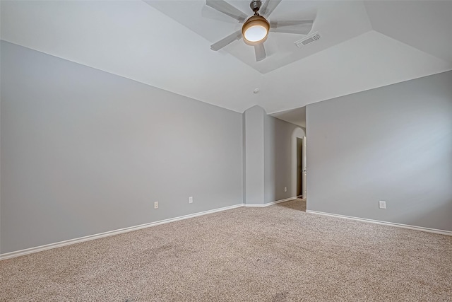 carpeted spare room featuring ceiling fan and vaulted ceiling